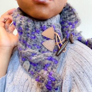 Hand crocheted purple and gray cable cowl with light tan toggle closure and pom poms on the corners hand made by MiasWorkshop