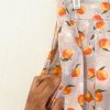 Up close photo of the pocket on the Spring Oranges Skirt -skirt with gray background and oranges pattern. Has pockets, and pleats. Fitted waistband. Zips closed at the left side