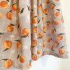 Spring Oranges Skirt -skirt with gray background and oranges pattern. Has pockets, and pleats. Fitted waistband. Zips closed at the left side