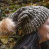 girl wearing taupe hand knit toboggan with tan pom pom adult sized from MiasWorkshop