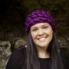 girl wearing a violet purple ear warmer or headband. The headband is hand crocheted in crocodile stitch.