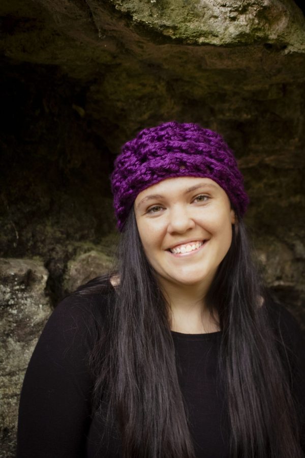 girl wearing a violet purple ear warmer or headband. The headband is hand crocheted in crocodile stitch.