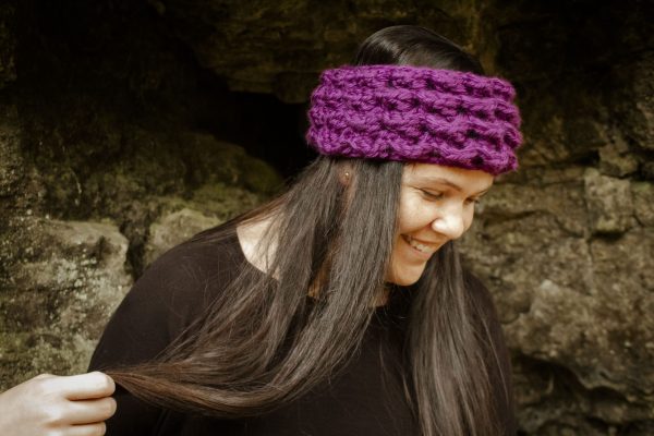 girl wearing a violet purple ear warmer or headband. The headband is hand crocheted in crocodile stitch.