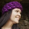 girl wearing a violet purple ear warmer or headband. The headband is hand crocheted in crocodile stitch.