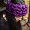 girl wearing a violet purple ear warmer or headband. The headband is hand crocheted in crocodile stitch.