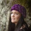 girl wearing a violet purple ear warmer or headband. The headband is hand crocheted in crocodile stitch.